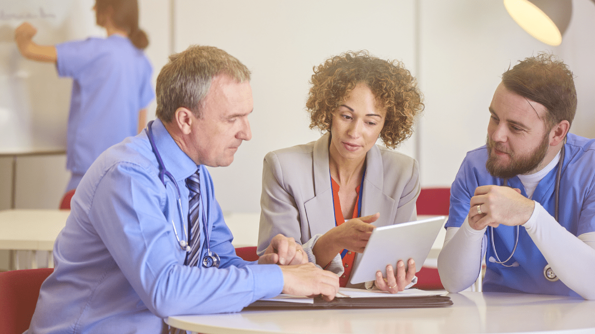 Hospital executives reviewing data on a screen